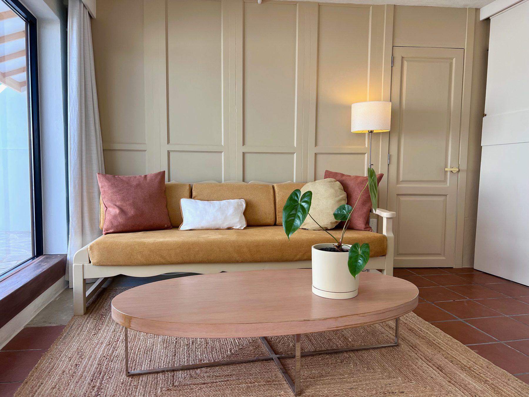 The lounge — sofa against the panelled wall